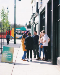 A group of people outside the church venue